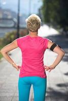 jogging woman setting phone before jogging photo