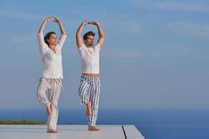 young couple practicing yoga photo