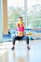 weights lifting  and working on her biceps in a gym photo