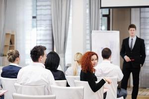 Young  business man giving a presentation on conference photo