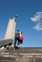 young  couple jogging on steps photo