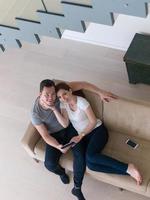 couple relaxing at  home with tablet computers photo
