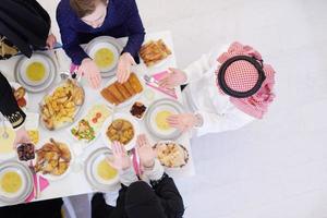 traditional muslim family praying before iftar dinner top view photo