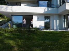 couple enjoying on the door of their luxury home villa photo