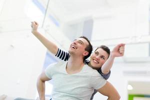 handsome man piggybacking his girlfriend photo