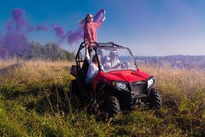 group of young people having fun while driving a off road buggy car photo