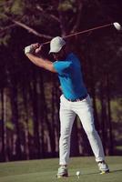 golf player hitting shot photo