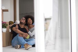 African American couple relaxing in new house photo