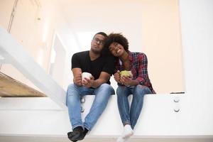 couple having break during moving to new house photo