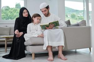 Young muslim family reading Quran during Ramadan photo