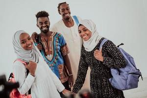 Group of happy african students having conversation and team meeting working together on homework girls wearing traidiional sudan muslim hijab fashion photo