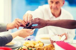 modern multiethnic muslim family sharing a bowl of dates photo