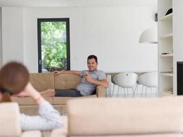 young man using a mobile phone  at home photo