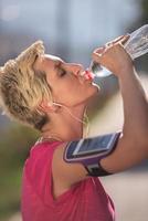 woman drinking  water after  jogging photo