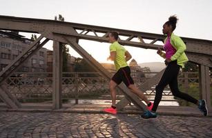 young multiethnic couple jogging in the city photo