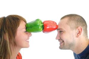happy couple holding peppers with head photo