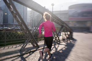 sporty woman jogging on morning photo