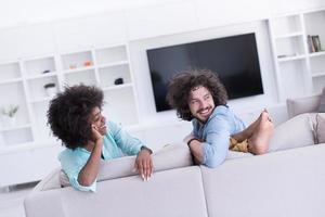 young multiethnic couple in living room photo