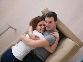 young handsome couple hugging on the sofa photo