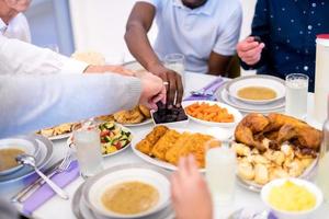 modern multiethnic muslim family sharing a bowl of dates photo