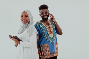 Young african business team woman wearing traditional sudan muslim hijab clothes using tablet computer isolated on white background students couple photo