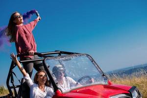 group of young people having fun while driving a off road buggy car photo