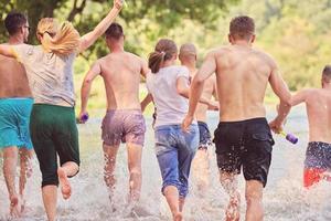 grupo de amigos felices divirtiéndose en el río foto