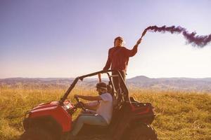 group of young people having fun while driving a off road buggy car photo