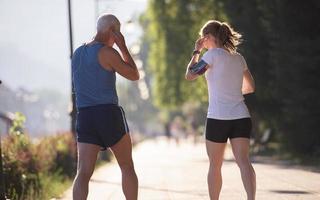 jogging couple planning running route  and setting music photo