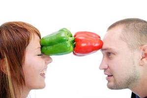 happy couple holding peppers with head photo