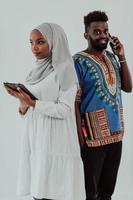 Young African business team woman wearing traditional clothes using tablet computer isolated on white background students couple photo