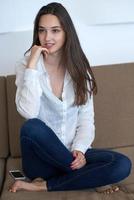 relaxed young woman at home working on laptop computer photo