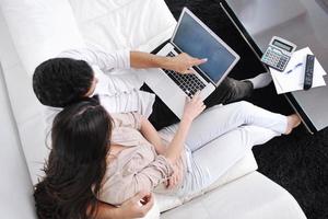 joyful couple relax and work on laptop computer at modern home photo