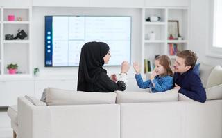 Happy Muslim family having fun at home photo