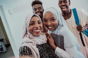 A group of multiethnic students take a selfie with a smartphone on a white background. Selective focus photo