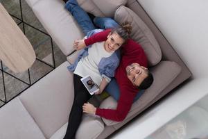 couple relaxing at  home with tablet computers photo