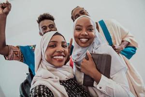 A group of multiethnic students take a selfie with a smartphone on a white background. Selective focus photo