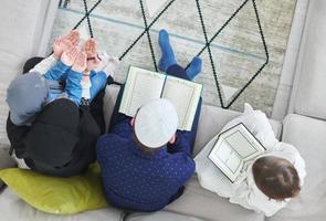 Top view of young muslim family reading Quran during Ramadan photo