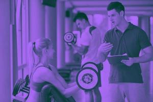 young sporty woman with trainer exercise weights lifting photo