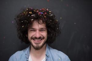 man blowing confetti in the air photo