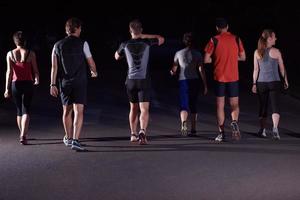 people group jogging at night photo