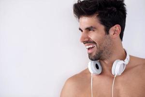 handsome young man listening music on headphones photo