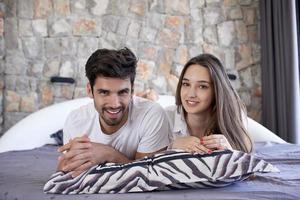 couple relax and have fun in bed photo