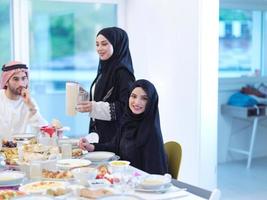 Muslim family having Iftar dinner drinking water to break feast photo
