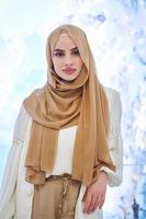 Girl wearing hijab posing on winter concept background photo