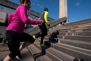 young  couple jogging on steps photo