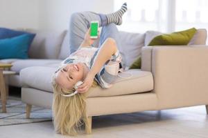 girl enjoying music through headphones photo