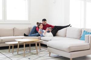 couple relaxing at  home with tablet computers photo