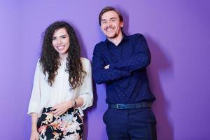 portrait of young couple isolated over purple background photo