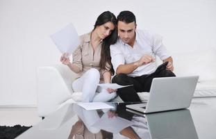 joyful couple relax and work on laptop computer at modern home photo